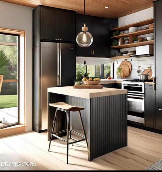 kitchen featuring light countertops, light wood-style flooring, appliances with stainless steel finishes, wooden ceiling, and open shelves