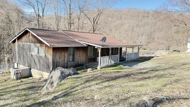 234 Habersham Rd, Duff, TN 37729 - view of front of home with central air condition unit, a porch, a shingled roof, and a front lawn