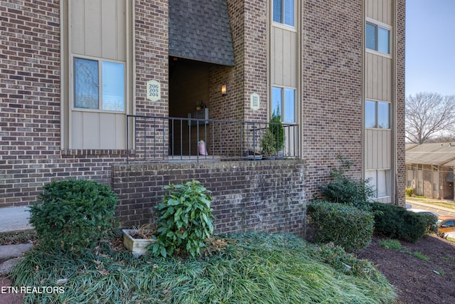 view of property exterior with brick siding and board and batten siding