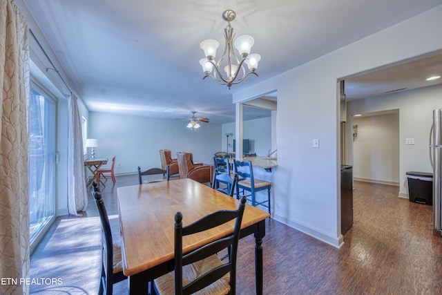 dining space with baseboards, wood finished floors, and ceiling fan with notable chandelier