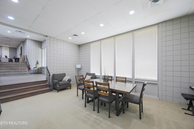 dining space with tile walls, recessed lighting, visible vents, and carpet floors