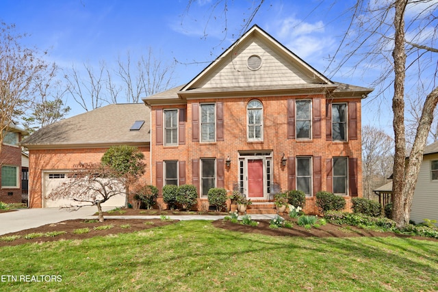 view of front of house featuring a front lawn, an attached garage, brick siding, and driveway