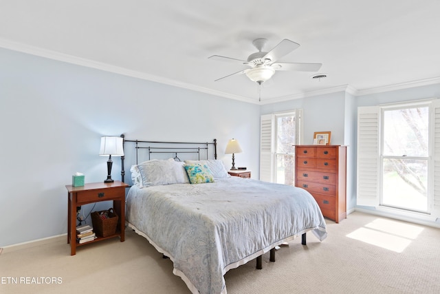 bedroom with multiple windows, light carpet, baseboards, and crown molding