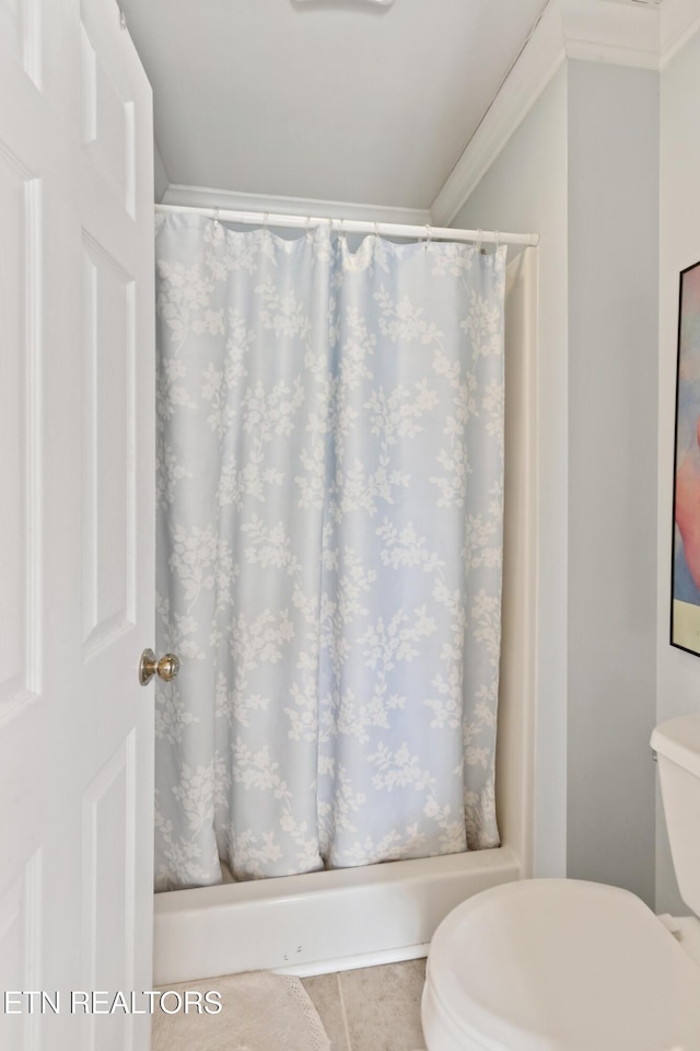 bathroom with tile patterned floors, curtained shower, and toilet