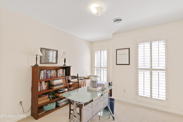 carpeted home office with baseboards and visible vents