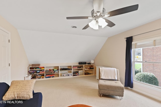 sitting room with visible vents, carpet flooring, baseboards, and vaulted ceiling