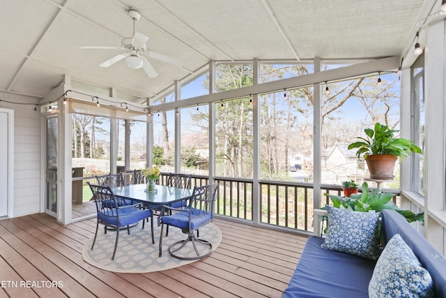 sunroom with lofted ceiling and a ceiling fan