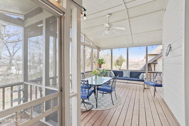 sunroom featuring ceiling fan and vaulted ceiling