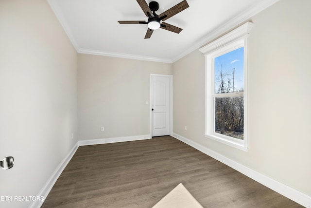 spare room with baseboards, crown molding, ceiling fan, and wood finished floors