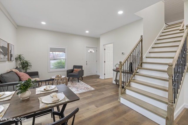 living area featuring recessed lighting, baseboards, stairway, and wood finished floors