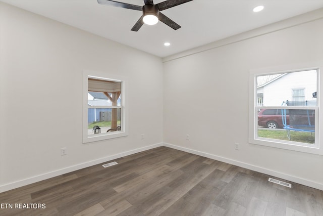 spare room with visible vents, baseboards, ceiling fan, recessed lighting, and dark wood-style floors
