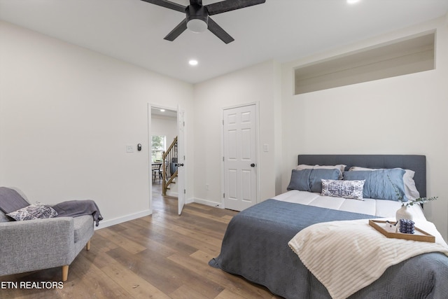 bedroom with baseboards, wood finished floors, ceiling fan, and recessed lighting
