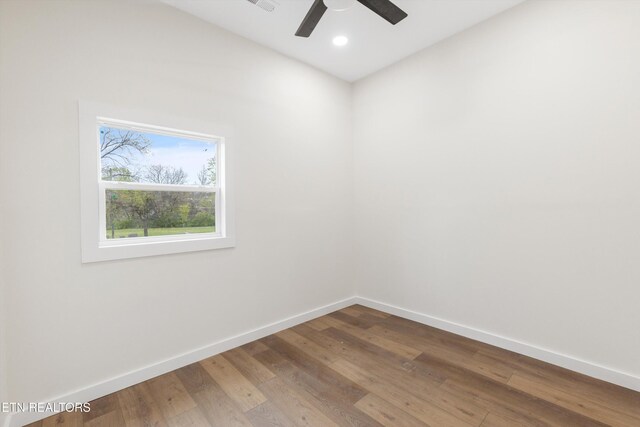 spare room featuring visible vents, hardwood / wood-style flooring, baseboards, ceiling fan, and recessed lighting