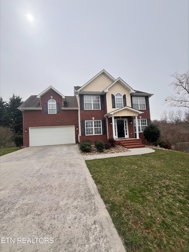 view of front of house with concrete driveway, a garage, brick siding, and a front yard