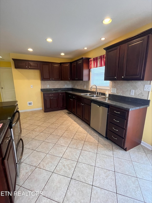 kitchen with light tile patterned flooring, a sink, stainless steel appliances, dark countertops, and tasteful backsplash