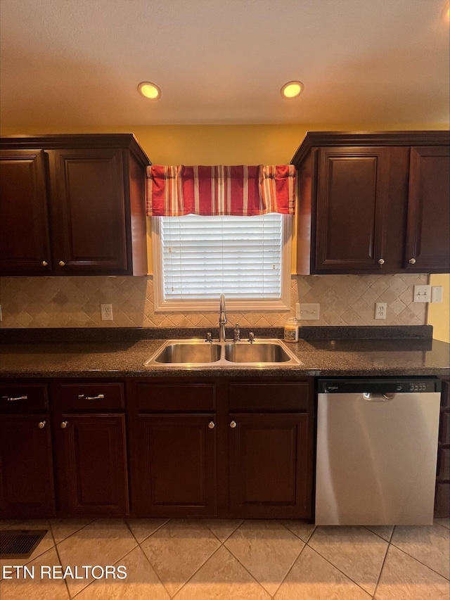 kitchen featuring dishwasher, dark countertops, tasteful backsplash, and a sink