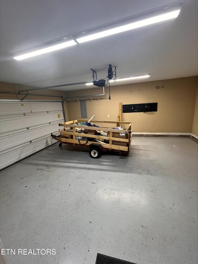 garage featuring electric panel and a garage door opener