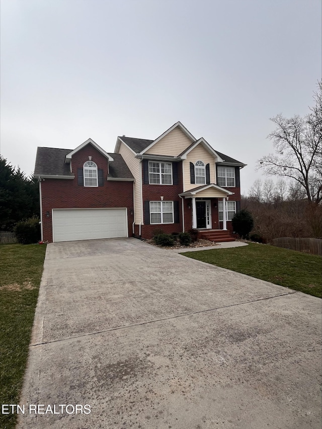 traditional home with brick siding, driveway, an attached garage, and a front lawn