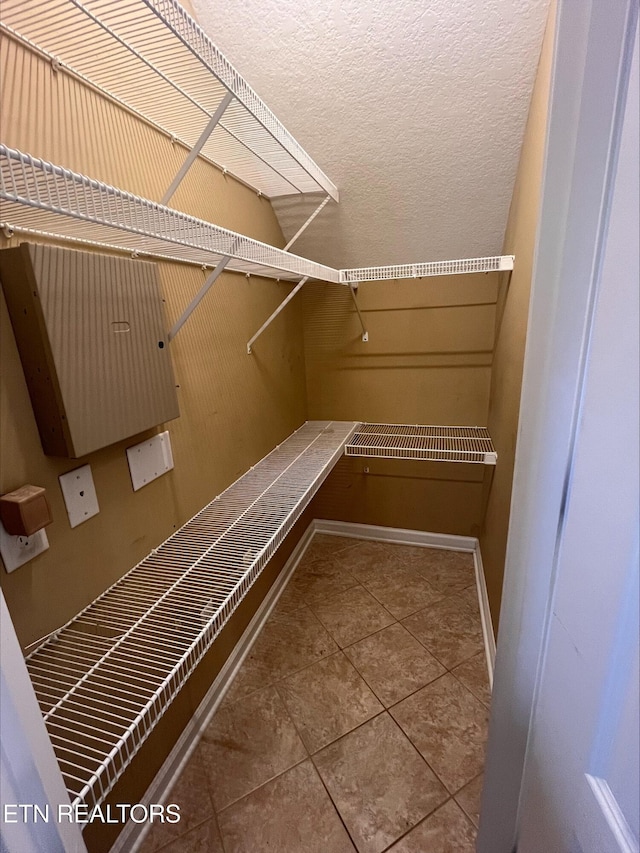 spacious closet featuring tile patterned floors