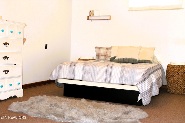 bedroom featuring baseboards and carpet floors