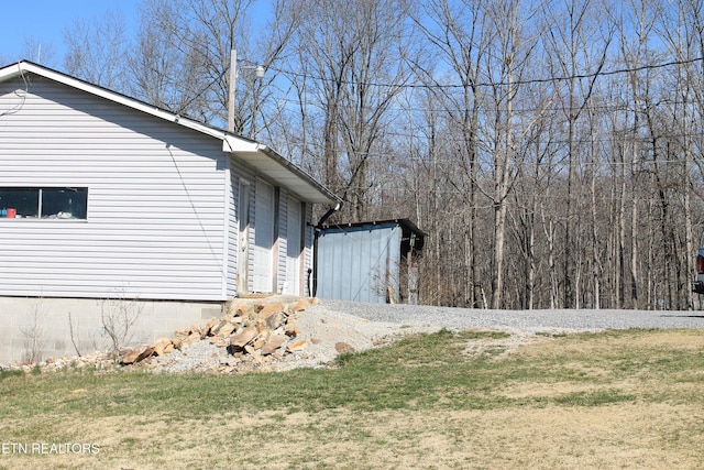 view of property exterior featuring a lawn