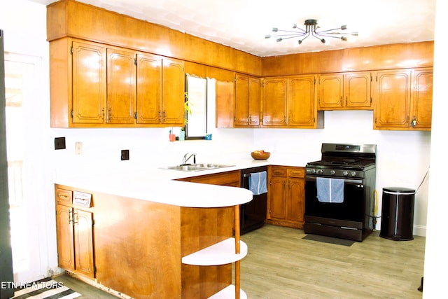 kitchen with a sink, stainless steel gas stove, black dishwasher, and brown cabinetry