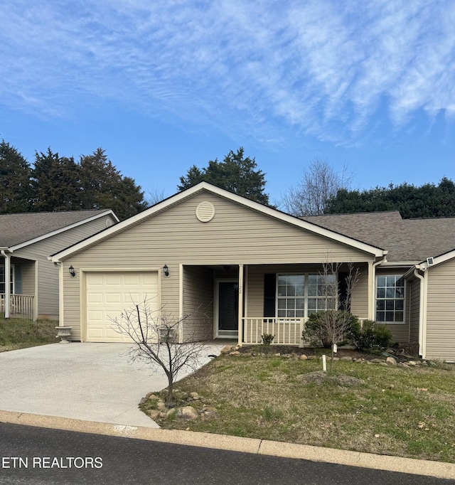 single story home with a porch, an attached garage, concrete driveway, and roof with shingles