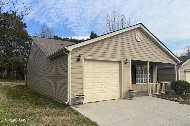 view of side of property with concrete driveway, a garage, covered porch, and a shingled roof