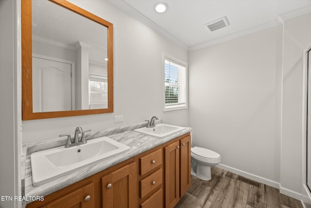 1600 Anna Maria Ln, Cookeville, TN 38501 - bathroom with wood finished floors, toilet, double vanity, crown molding, and baseboards