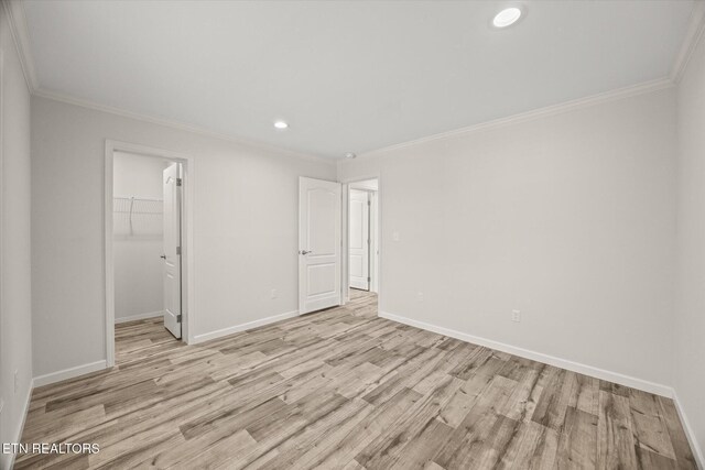 1600 Anna Maria Ln, Cookeville, TN 38501 - unfurnished bedroom with light wood-style flooring, baseboards, recessed lighting, crown molding, and a walk in closet