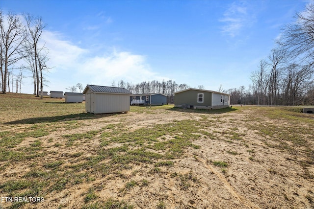 1600 Anna Maria Ln, Cookeville, TN 38501 - view of grassy yard with a storage unit and an outbuilding