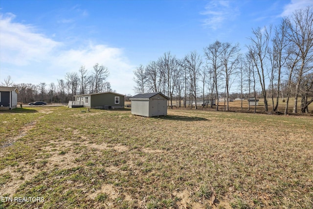 1600 Anna Maria Ln, Cookeville, TN 38501 - view of grassy yard with a storage unit and an outbuilding