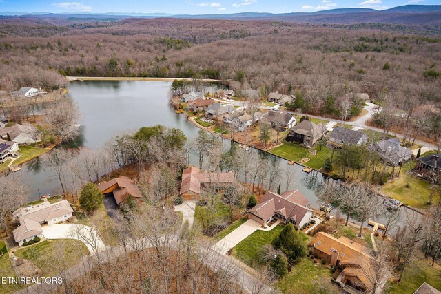 birds eye view of property with a water view and a residential view