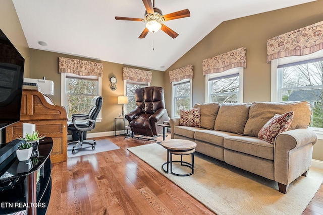 living area with hardwood / wood-style flooring, plenty of natural light, and lofted ceiling