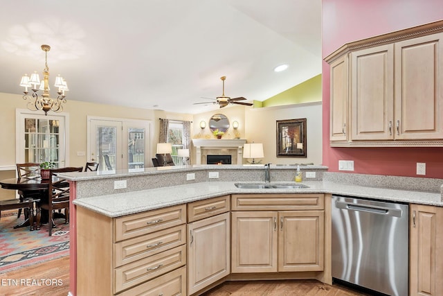 kitchen featuring dishwasher, light brown cabinetry, and a sink