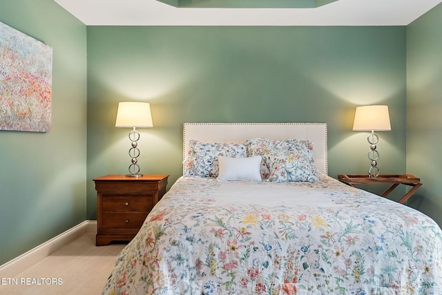 carpeted bedroom featuring baseboards