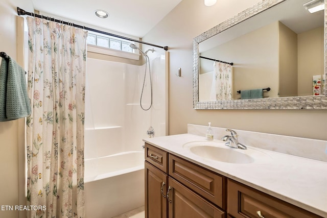 bathroom featuring vanity and shower / bathtub combination with curtain