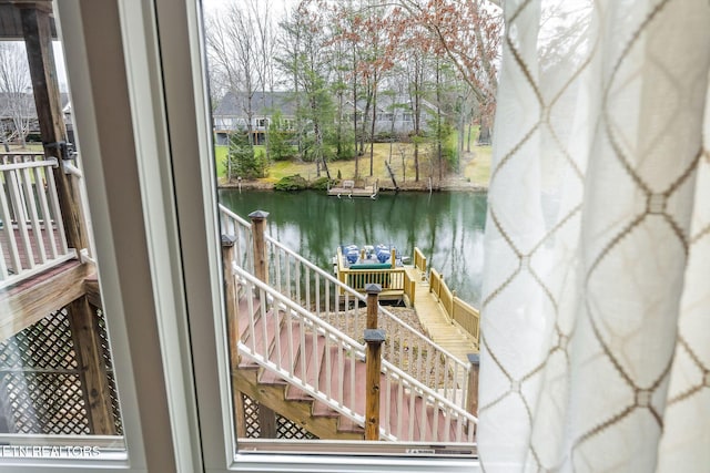 balcony featuring a water view and a boat dock