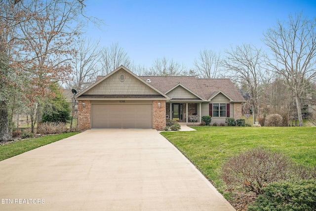 view of front of property featuring a garage, driveway, brick siding, and a front yard