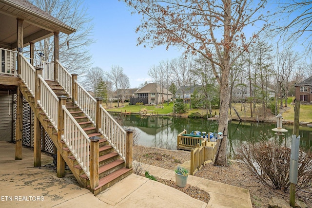 exterior space featuring a residential view, a water view, and stairs