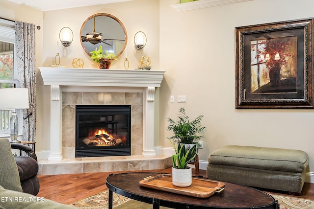 sitting room with wood finished floors and a fireplace