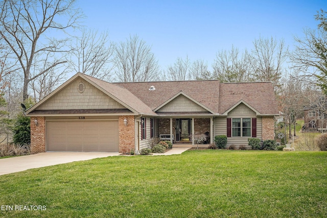 view of front of home featuring a front yard, driveway, roof with shingles, a garage, and brick siding