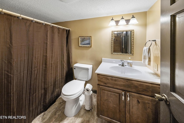 bathroom featuring toilet, a textured ceiling, vanity, and a shower with curtain