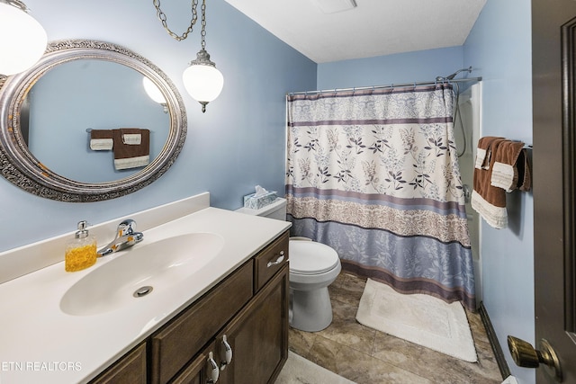 bathroom featuring vanity, a shower with shower curtain, and toilet