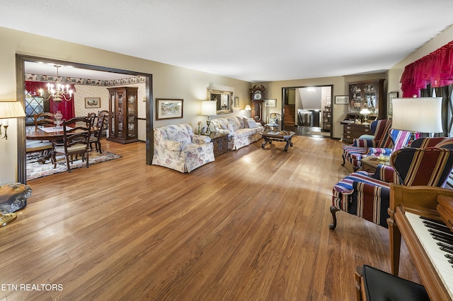 living room with an inviting chandelier and wood finished floors