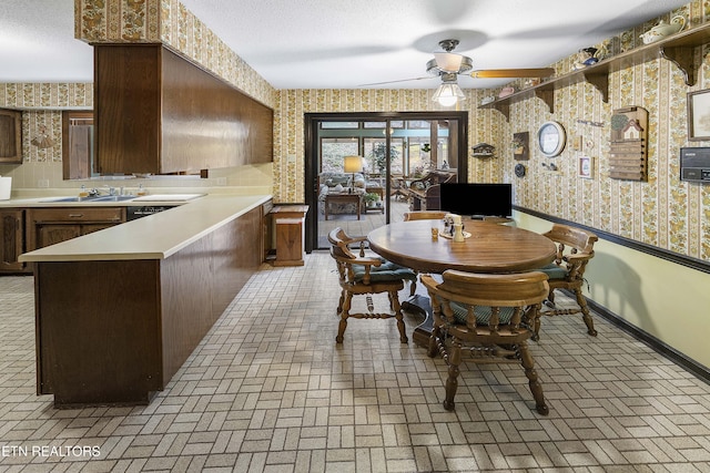 dining area with brick patterned floor, wallpapered walls, and a textured ceiling