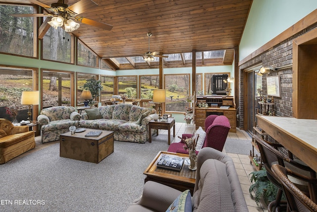 sunroom / solarium with lofted ceiling, wooden ceiling, a wealth of natural light, and ceiling fan