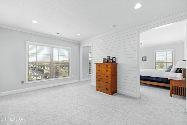 bedroom featuring crown molding, baseboards, and carpet floors