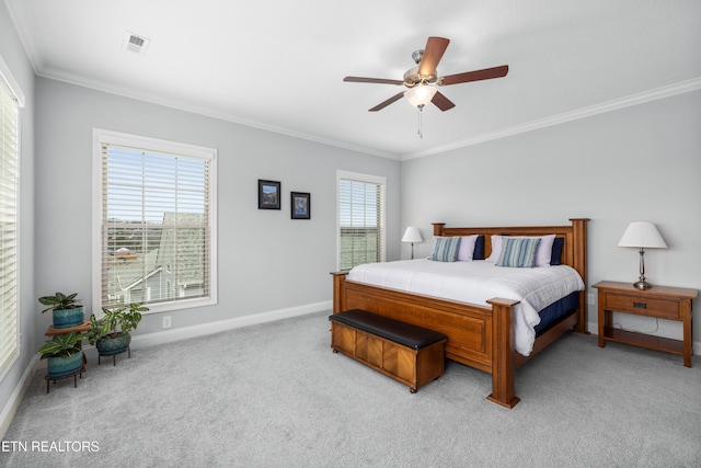 bedroom featuring visible vents, baseboards, light colored carpet, ornamental molding, and a ceiling fan