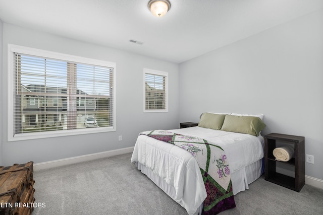 bedroom with visible vents, baseboards, and carpet floors